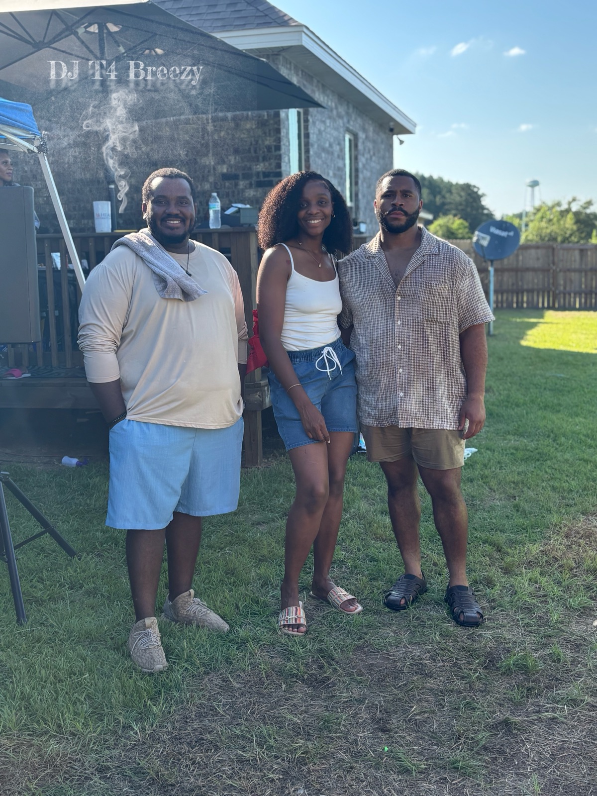 DJ T4 Breezy with two guests at an outdoor backyard party